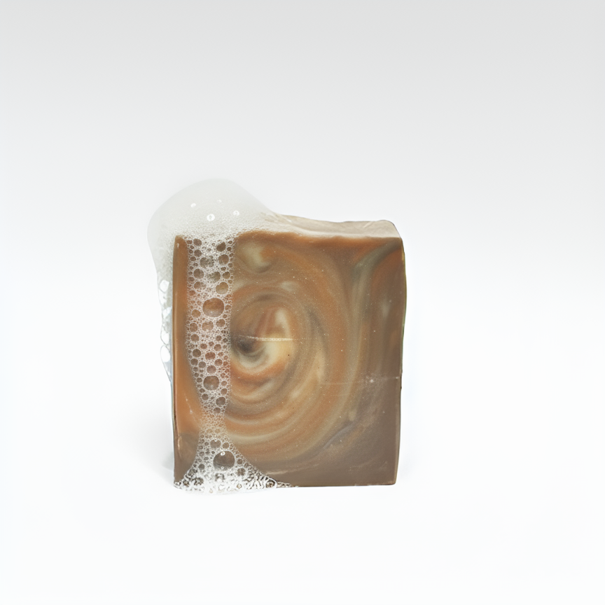 Swirled brown soap bar with lather on a white background