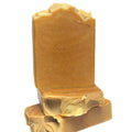 Brown soap bar with a decorative top on a white background