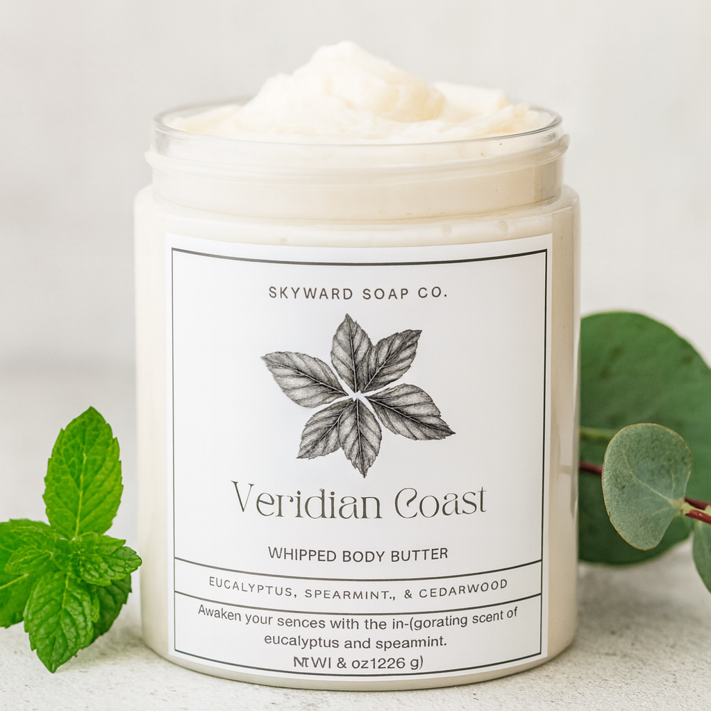 Whipped body butter jar with 'Veridian Coast' label on a light background with spearmint and eucalyptus leaves